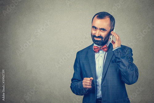 man talking on mobile phone looking and smiling