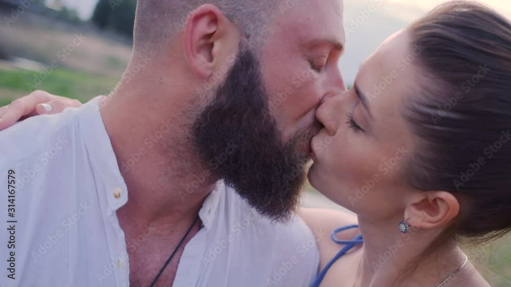 A couple in love on a summer day.Lovers hug and kiss.Bearded guy with his girlfriend close up A couple in love on a summer day.Lovers hug and kiss.Bearded guy with his girlfriend close up