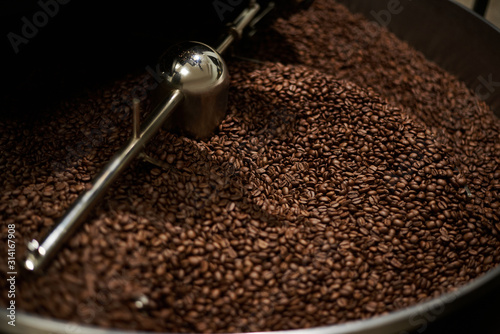 Coffee beans roasted well in a coffee roasting machine. Close-up.