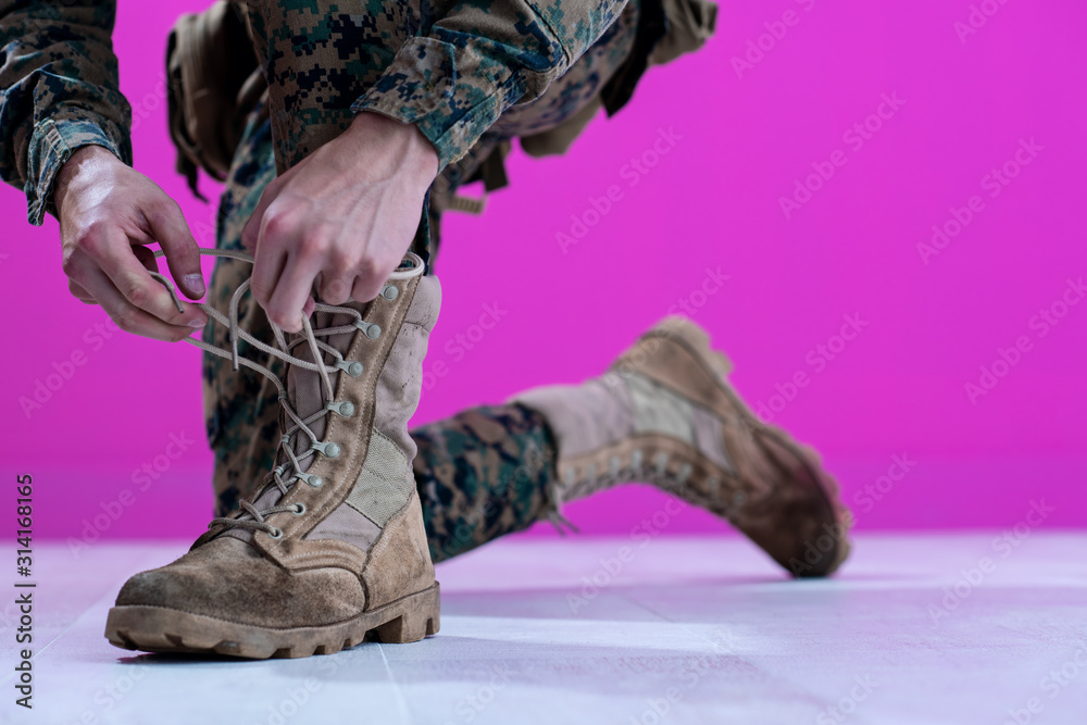 soldier tying the laces on his boots