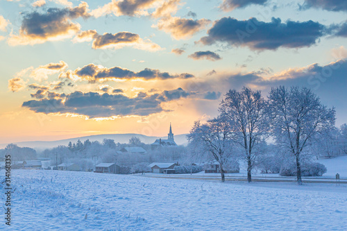 Snowy Sunrise Over A  Rural Church