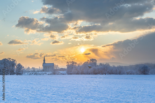 Winter Sunrise Over A Rural Church