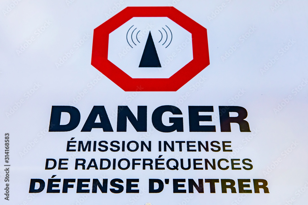 A close up view of a French sign in Quebec, Canada, saying Danger, intense  emission of radio frequencies, no entry. Entry forbidden at cell site tower  Stock Photo | Adobe Stock