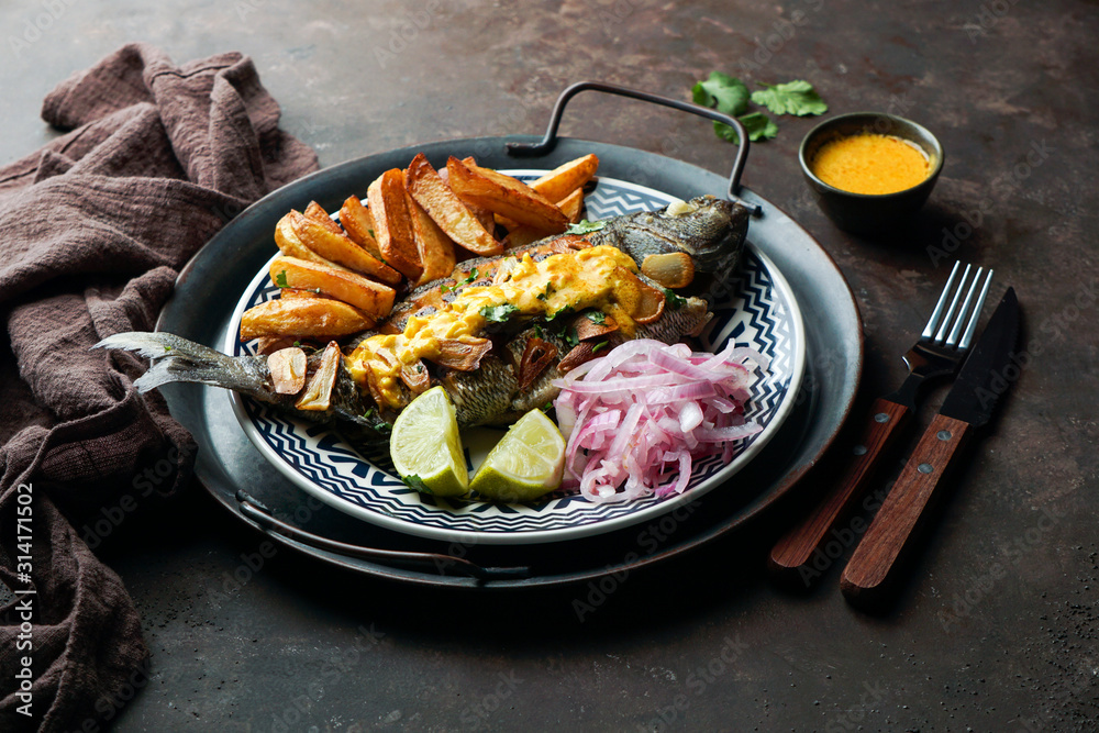 Chita frita al ajo, al ajillo, Peruvian food, a whole fish, served wit ...