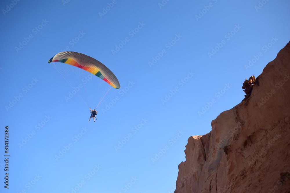 People paragliding flying over the beach People paragliding flying over the beach