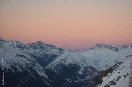 Snowy mountains in hazy sunset