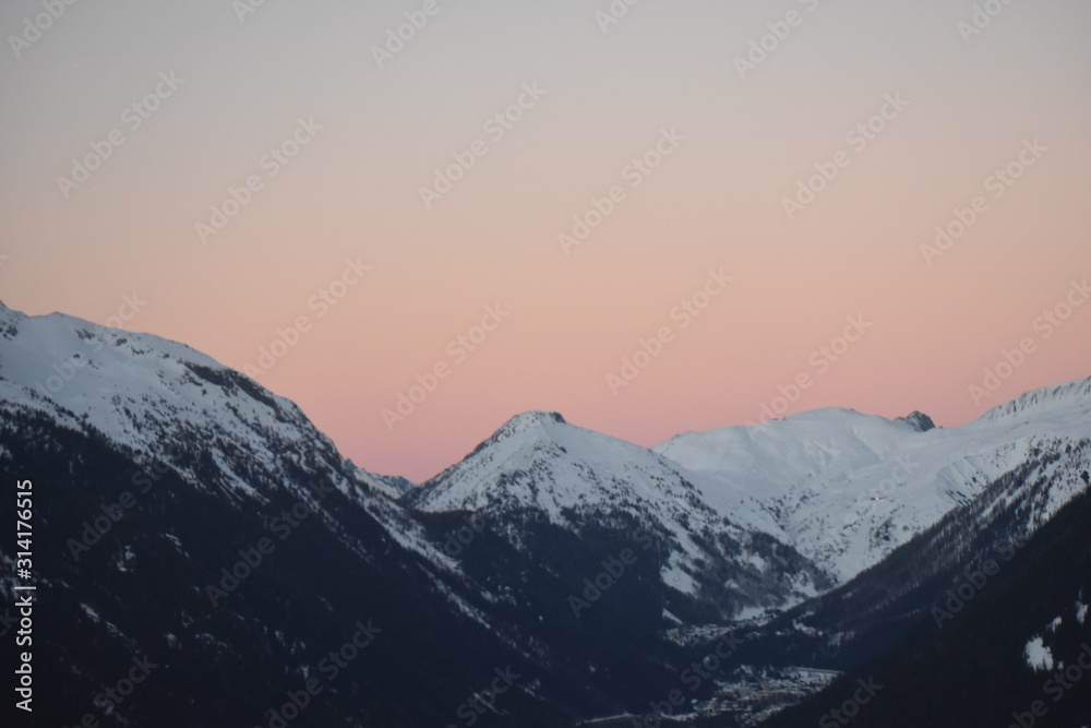 snowy mountain tops in sunset