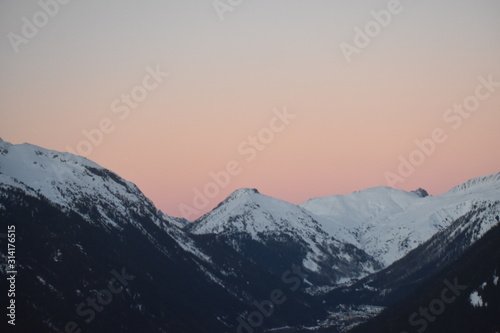 snowy mountain tops in sunset