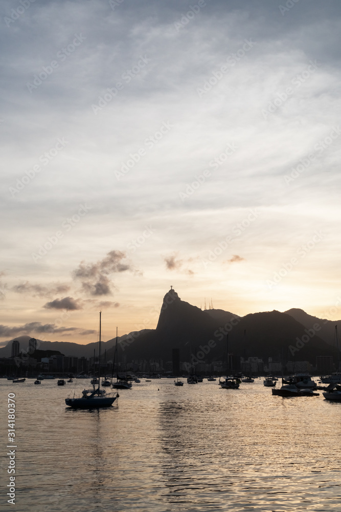 Sunset from Mureta da Urca in Rio de Janeiro, over the mountains and Christ the Redeemer Statue.