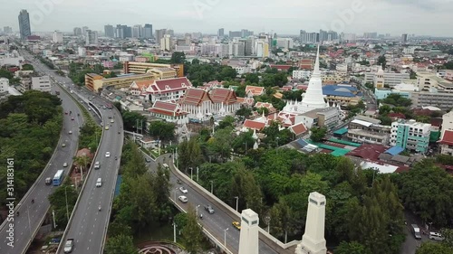 Typical Bangkok Thailand Cityscape. Busy Urban City Freeway Traffic and Buddhist Temple, Cinematic Aerial View photo