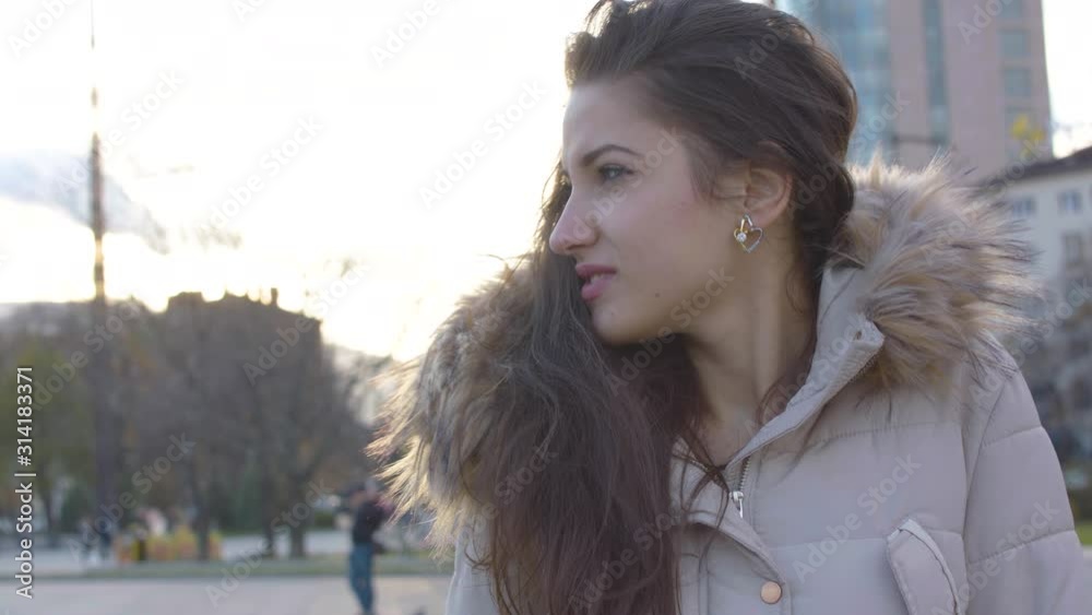 Beautiful girl waiting for someone in a cold, windy day Beautiful girl waiting for someone in a cold, windy day