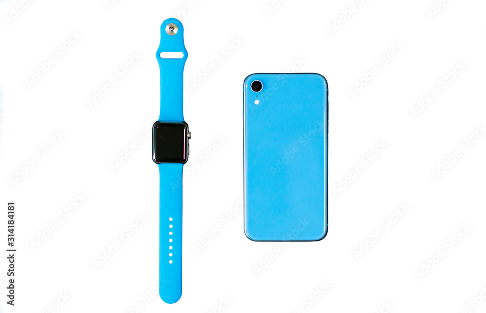 New modern gadgets, isolate devices: Smart Watch with blue sport band, blue cell mobile phone isolated on white background. Top view. Fitness smartwatches. Wearable technology concept.