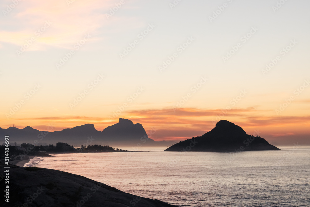 Golden dawn sunrise from Mirante do Roncador over Recreio Beach and the mountains of Rio de Janeiro.