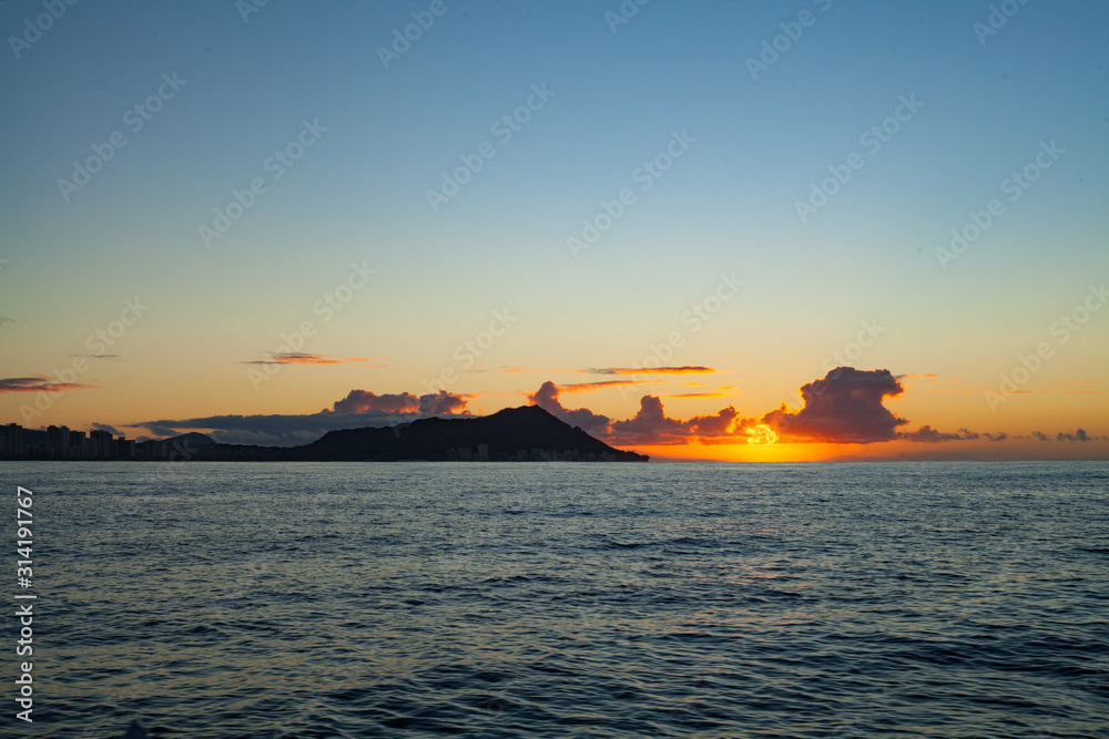 Beautiful Orange Sunrise over the Ocean from a Boat - Waikiki Sunrise over Diamondhead