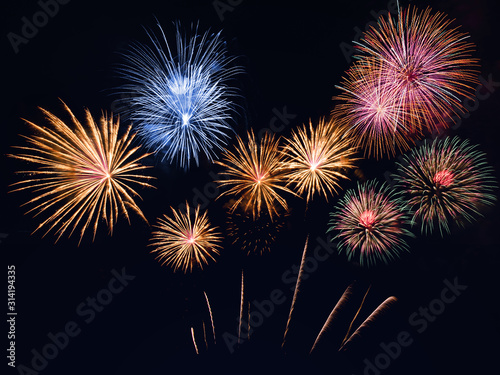 colorful fireworks on the black sky background with free space for text. Celebration and anniversary concept