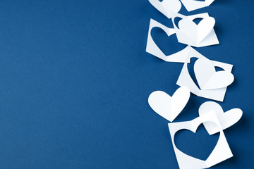 Valentine background with white blue paper craft hearts border on classic blue background, Happy lovers day card mockup, copy space, winter february romance concept