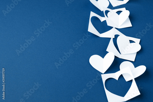Valentine background with white blue paper craft hearts border on classic blue background, Happy lovers day card mockup, copy space, winter february romance concept photo