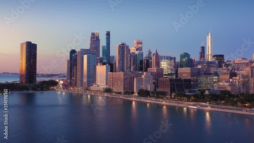 Wallpaper Mural Aerial: Morning rush hour traffic on North Lake Shore Drive alongside Lake Michigan at sunrise. In the background is the Chicago city skyline.  Chicago, Illinois, USA. Torontodigital.ca