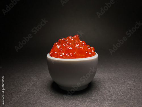 Red salmon caviar. Delicacy. Close-up on an isolated background.