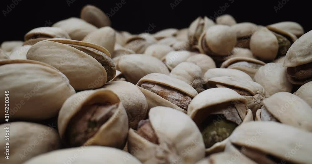 Roasted pistachios shot with a macro probe lens on a slider. Shot in studio in 4K RAW on a cinema camera. Roasted pistachios shot with a macro probe lens on a slider. Shot in studio in 4K RAW on a cinema camera.