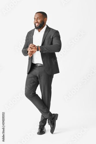 Stylish African-American man on white background © Pixel-Shot