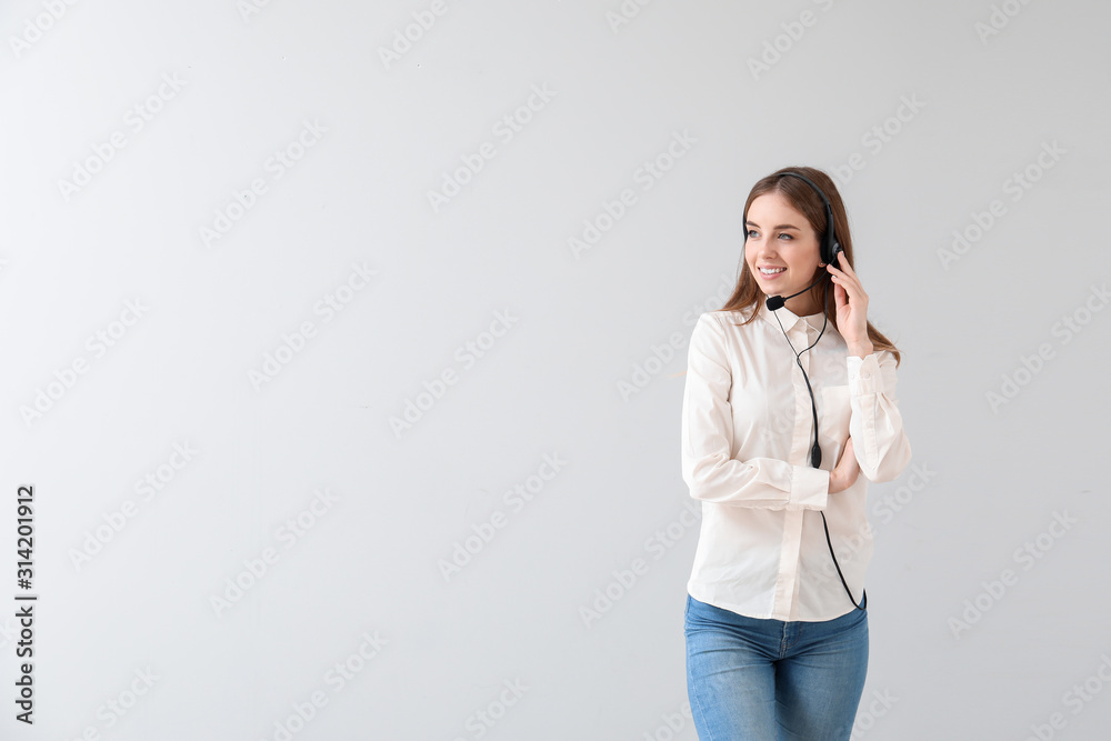 Female technical support agent on light background