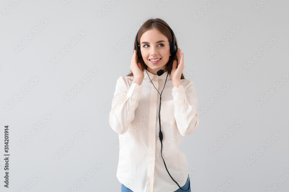 Female technical support agent on light background