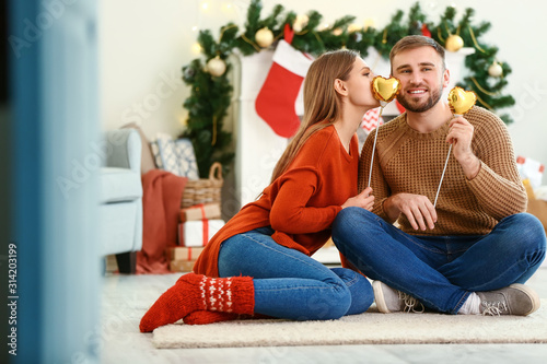 Happy young couple with hearts at home on Christmas eve © Pixel-Shot