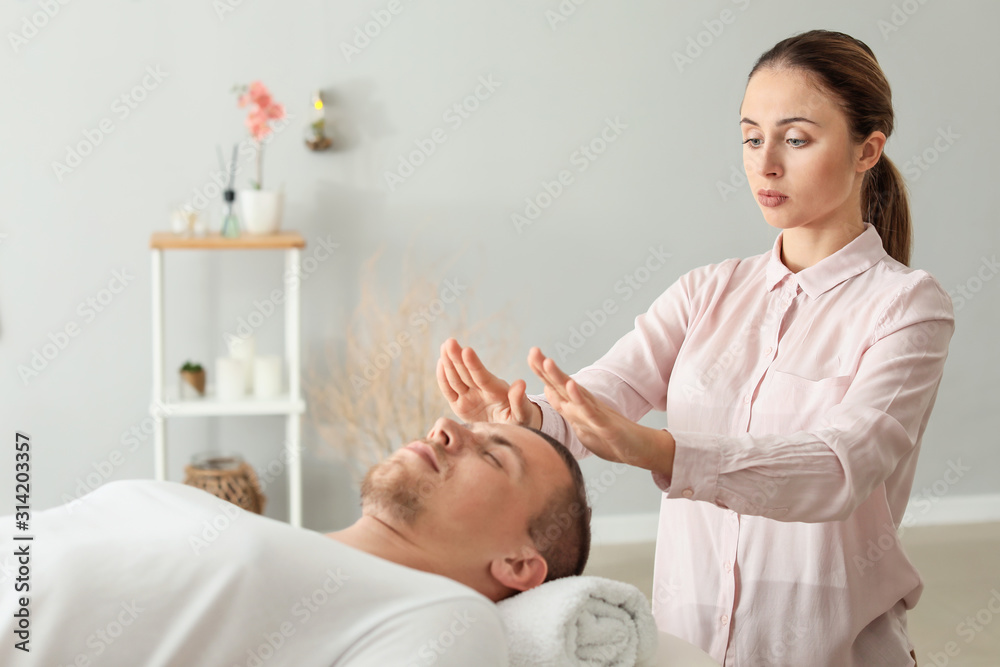 Fototapeta premium Reiki master working with patient