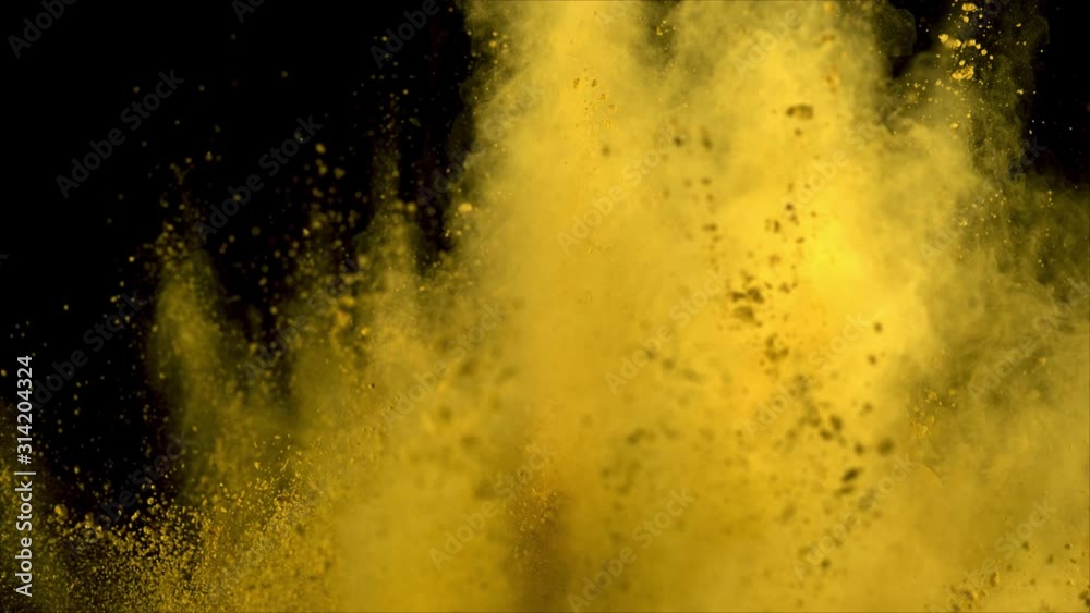 Realistic yellow powder explosion on black background in vertical motion