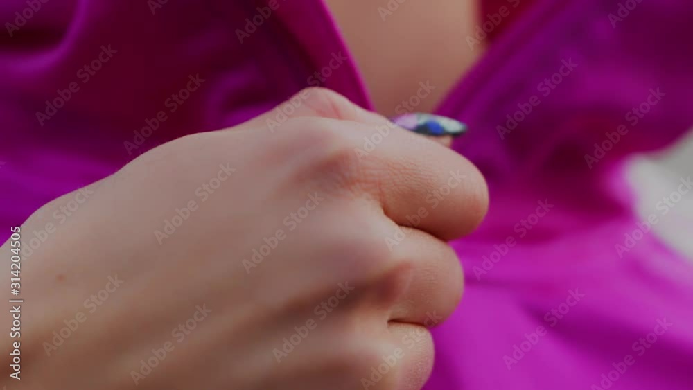 A Hand Of A Woman Zipping Her Pink Jacket - Close Up Shot A Hand Of A Woman Zipping Her Pink Jacket - Close Up Shot