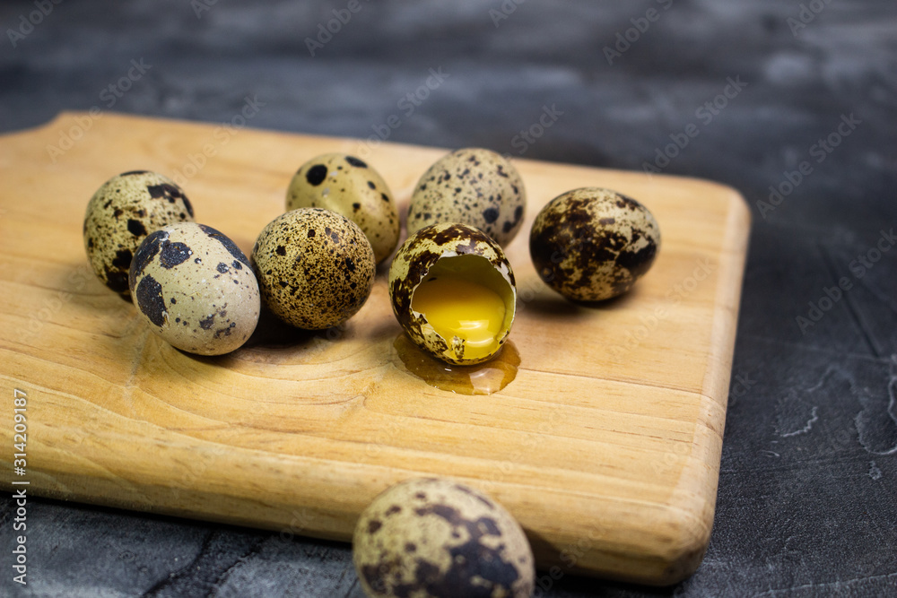 Quail eggs on wooden board , cooking concept Quail eggs on wooden board , cooking concept
