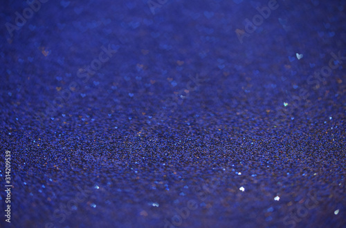 Abstract blue glitter background with hearts shaped bokeh. Super Macro shot of glittering paper. Valentines Day love beauty, fancy luxury concept. Banner, copy space.