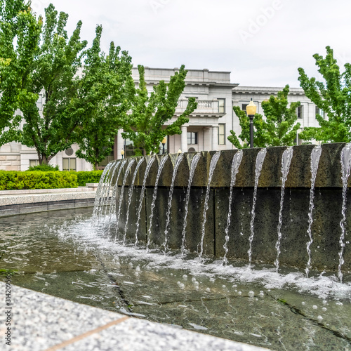 Square Water fountain with clear trickling water at Utah State Capitol Building © Jason