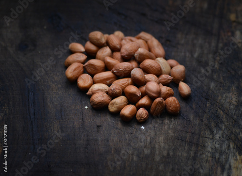 Peanuts or arachis hypogaea on old wood background