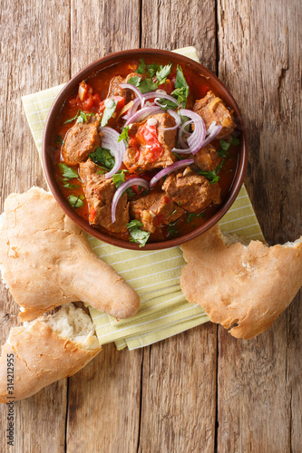 Spicy Georgian Beef Stew Chashushuli Ostri close-up in a bowl. Vertical top view photo