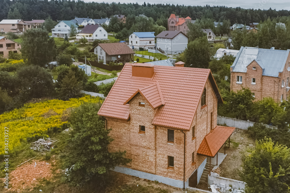 Beautiful pink brick brick house and orange roof. Corrugated met Beautiful pink brick brick house and orange roof. Corrugated met