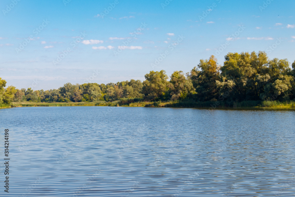 Summer landscape with beautiful river, green trees and blue sky Summer landscape with beautiful river, green trees and blue sky