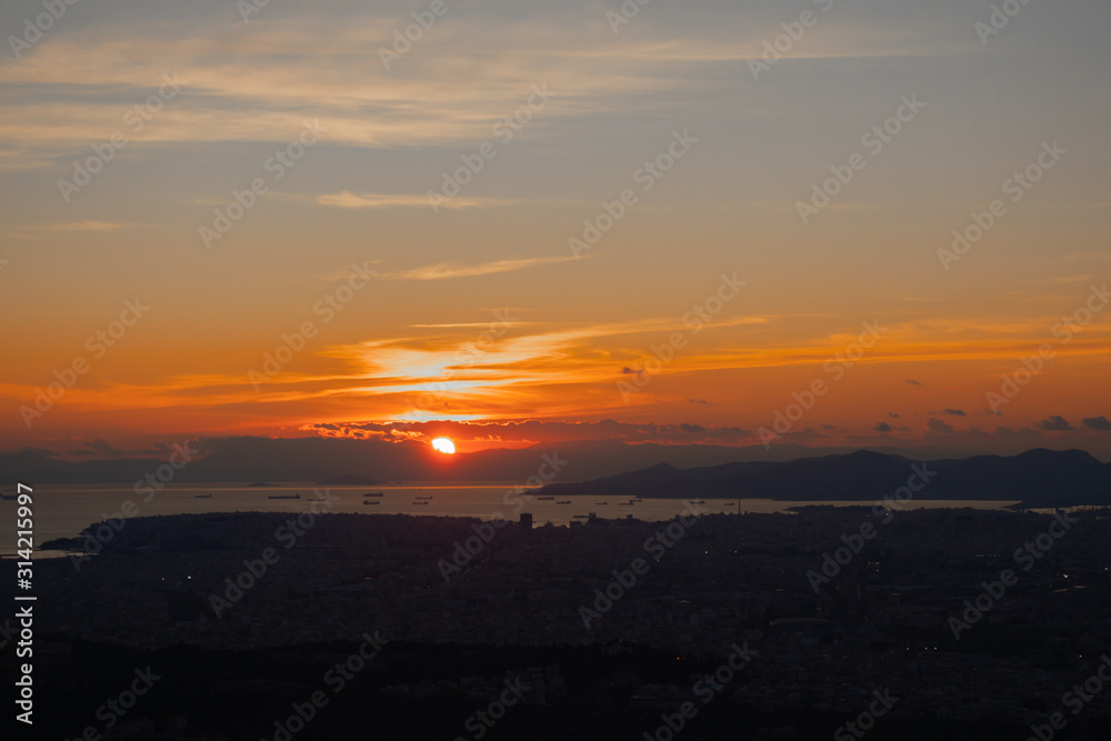 Fototapeta premium Sunset in Athens on a cloudy sky with a city view from Lycabettus hill