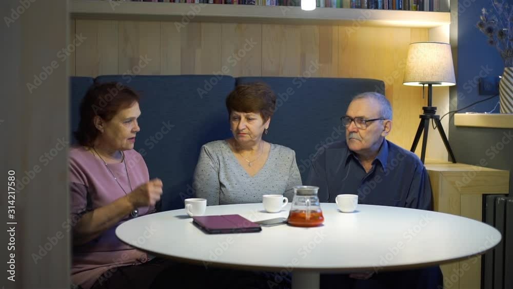 Gathering of Senior Friends in a Coffee Shop. They Drinking Tea and Talking. Slow Motion. Friendship, Retirement Age, Memories and People Concept Gathering of Senior Friends in a Coffee Shop. They Drinking Tea and Talking. Slow Motion. Friendship, Retirement Age, Memories and People Concept