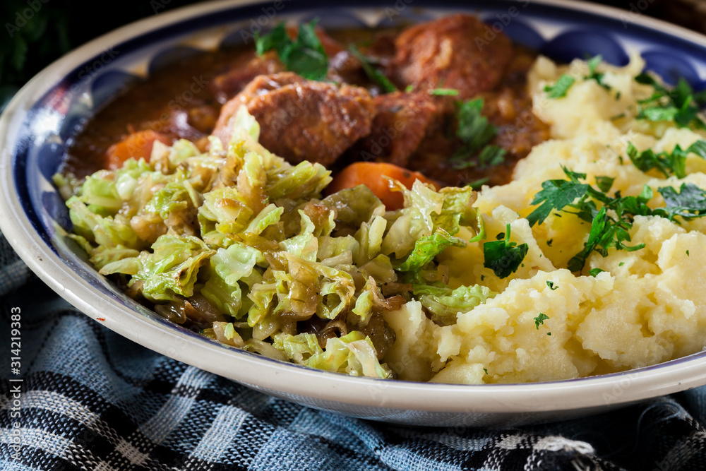Traditional irish stew served with potatoes and cabbage Traditional irish stew served with potatoes and cabbage