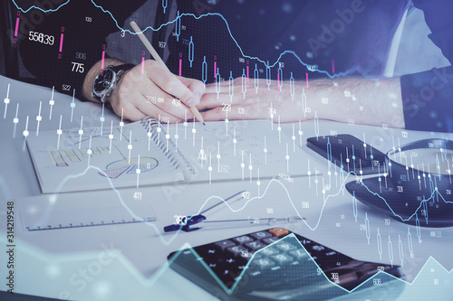 Double exposure of man doing analysis of stock market with forex graph.