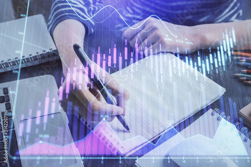 Financial chart drawn over hands taking notes background. Concept of research. Double exposure