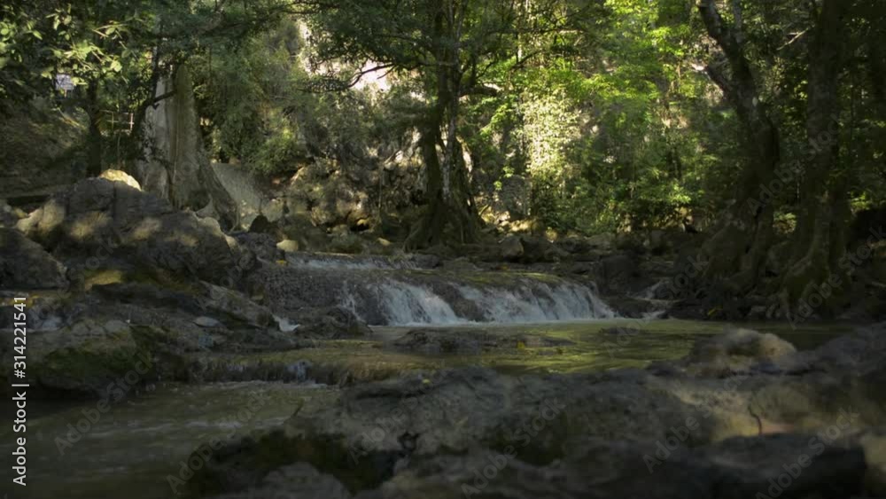 Scenery of waterfall under the shade of trees in rain forest with fresh water flowing from the mountain in thailand. Scenery of waterfall under the shade of trees in rain forest with fresh water flowing from the mountain in thailand.