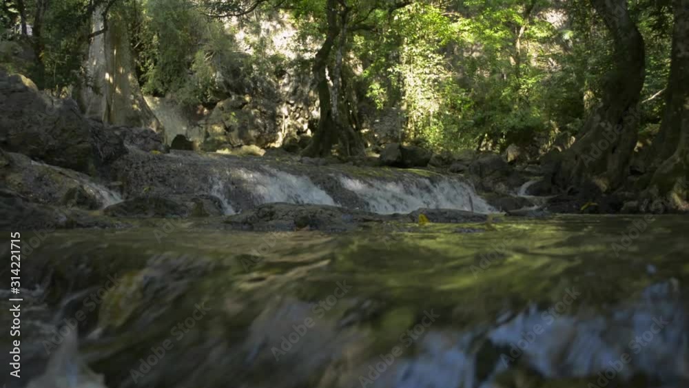 Scenery of waterfall under the shade of trees in rain forest with fresh water flowing from the mountain in thailand. Scenery of waterfall under the shade of trees in rain forest with fresh water flowing from the mountain in thailand.