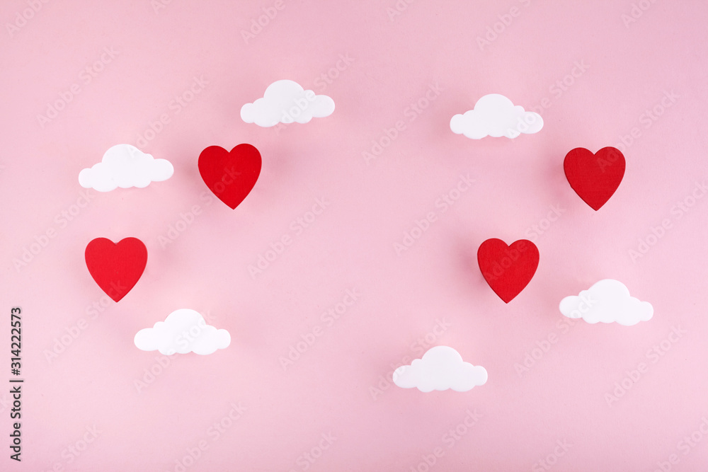 Valentine's day background. Red hearts and clouds on soft pink background feel like fluffy in the air