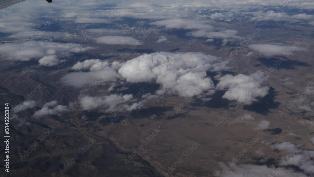 Aerial view of America above the clouds out of plane window 4k Aerial view of America above the clouds out of plane window 4k