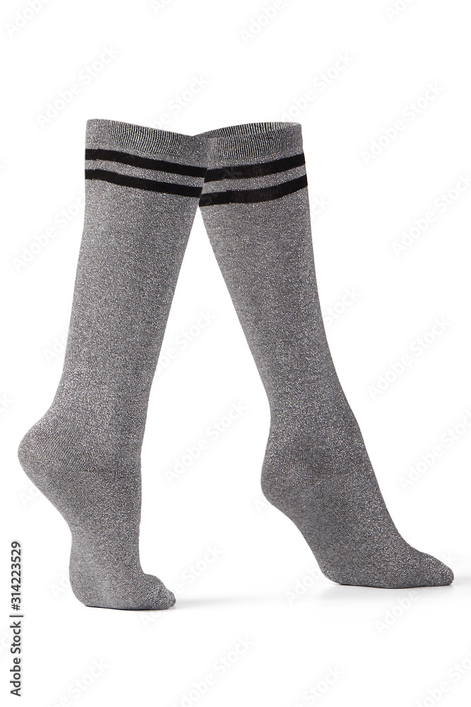 Subject shot of dense gray socks with silver lurex and black stripes on the top. The photo is made on the white background. Subject shot of dense gray socks with silver lurex and black stripes on the top. The photo is made on the white background.