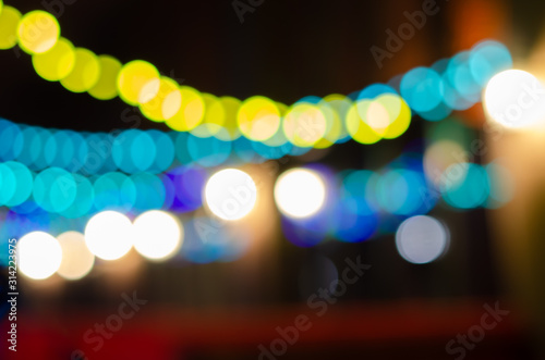 Abstract background with colored Garland light bokeh in dark. Bokeh abstract for background. © Анастасия Савченко