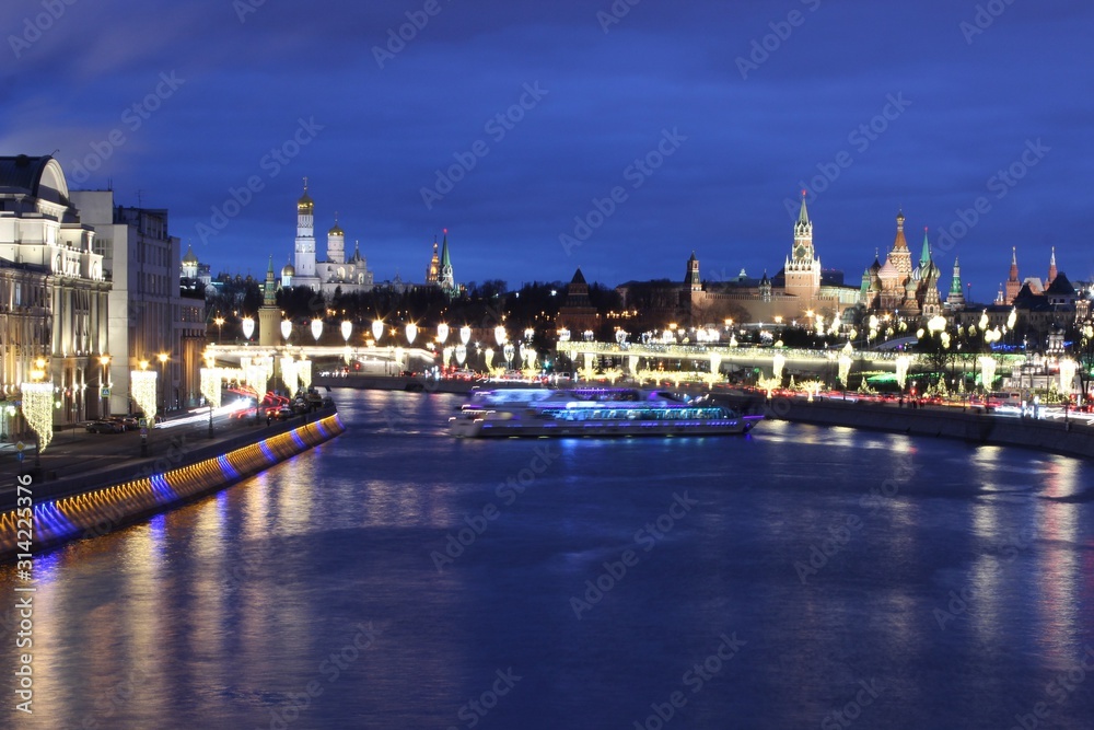 View of the red square and the river in Moscow in winter with a festive new year illumination
